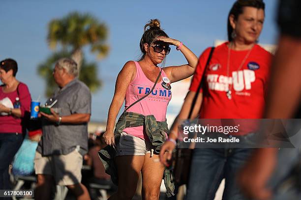 People arrive for the campaign rally of Republican presidential candidate Donald Trump at the MidFlorida Credit Union Amphitheatre on October 24,...