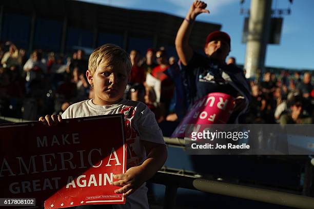 People wait for the arrival of Republican presidential candidate Donald Trump for his campaign rally at the MidFlorida Credit Union Amphitheatre on...