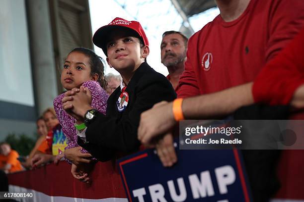 People wait for the arrival of Republican presidential candidate Donald Trump for his campaign rally at the MidFlorida Credit Union Amphitheatre on...