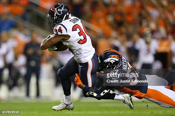 Running back Tyler Ervin of the Houston Texans catches a pass and then is tackled by linebacker Dekoda Watson of the Denver Broncos in the first...