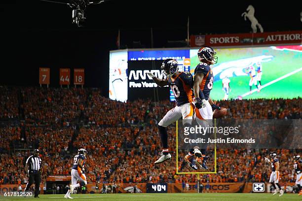 Wide receiver Demaryius Thomas of the Denver Broncos celebrate a touchdown with wide receiver Emmanuel Sanders in the second quarter of the game...