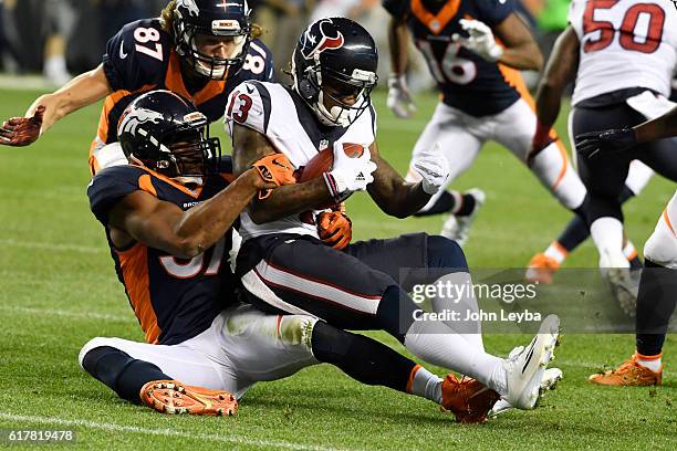 Dekoda Watson of the Denver Broncos stops Braxton Miller of the Houston Texans during the second quarter on Monday, October 24, 2016. The Denver...