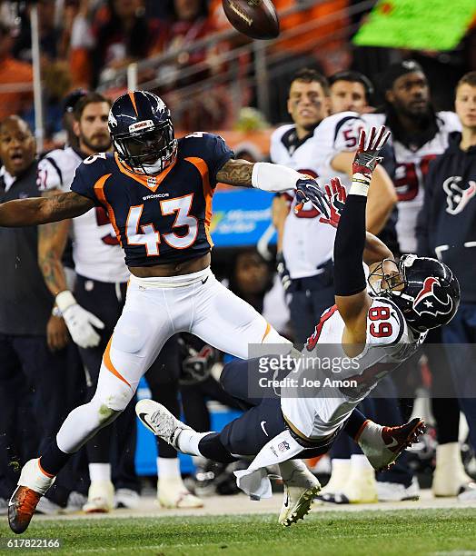 Stephen Anderson of the Houston Texans cannot bring down the catch as T.J. Ward of the Denver Broncos defends during the third quarter on Monday,...