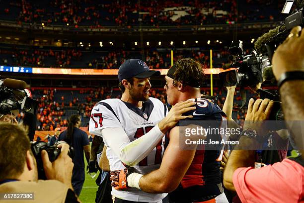 Brock Osweiler of the Houston Texans hugs Derek Wolfe of the Denver Broncos after the fourth quarter of the Broncos' 27-9 win on Monday, October 24,...