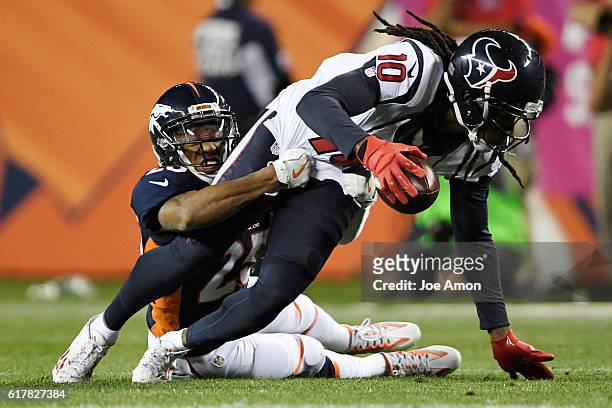 Chris Harris of the Denver Broncos tackles DeAndre Hopkins of the Houston Texans during the third quarter on Monday, October 24, 2016. The Denver...