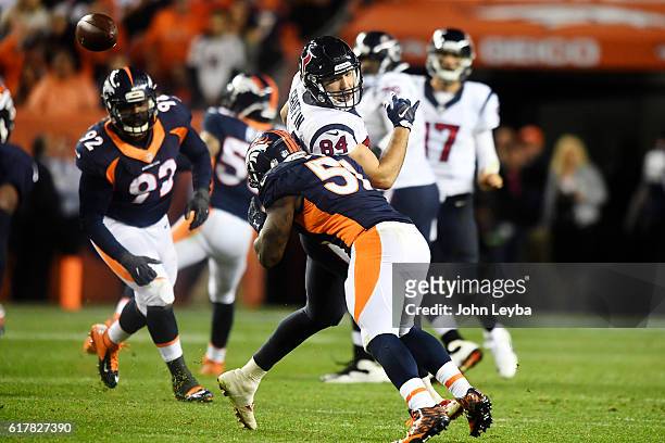 Todd Davis of the Denver Broncos hits Ryan Griffin of the Houston Texans to break up a pass during the fourth quarter on Monday, October 24, 2016....