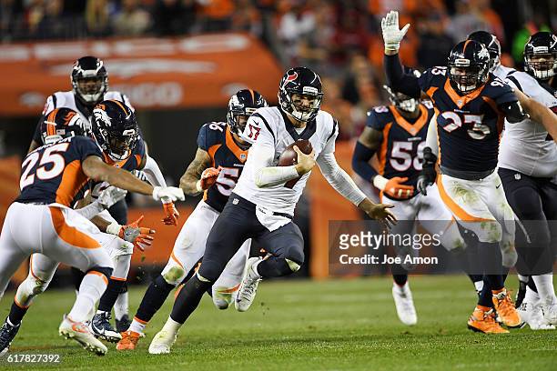 Brock Osweiler of the Houston Texans scrambles against the Denver Broncos defense during the third quarter on Monday, October 24, 2016. The Denver...