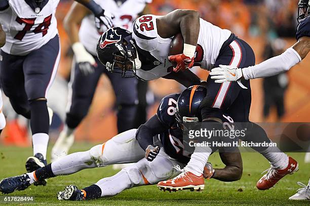 Darian Stewart of the Denver Broncos tackles Alfred Blue of the Houston Texans during the third quarter on Monday, October 24, 2016. The Denver...