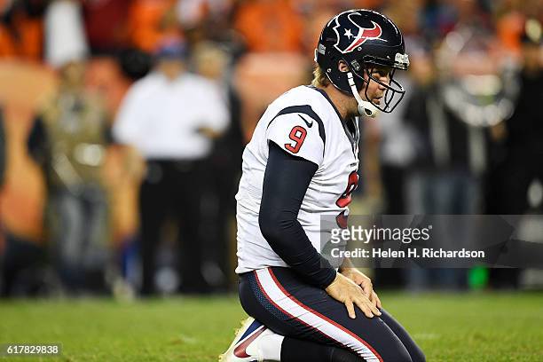 Shane Lechler of the Houston Texans kneels on the grass after taking contact on a punt from the Denver Broncos during the fourth quarter on Monday,...