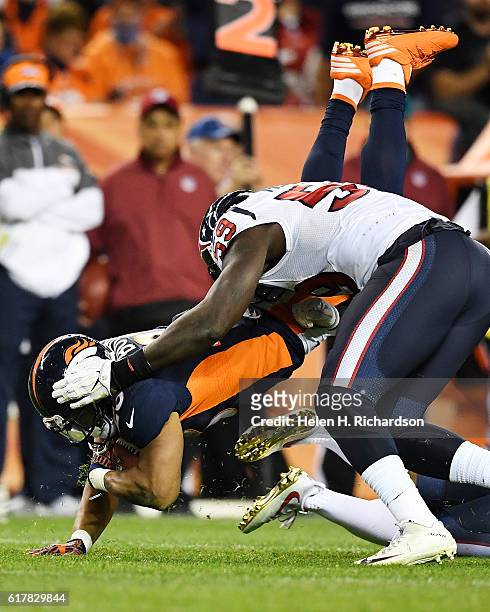 Whitney Mercilus of the Houston Texans tackles Devontae Booker of the Denver Broncos during the fourth quarter on Monday, October 24, 2016. The...