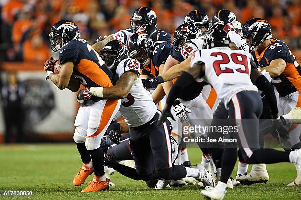 Devontae Booker of the Denver Broncos is tackled by Benardrick McKinney of the Houston Texans during the fourth quarter on Monday, October 24, 2016....