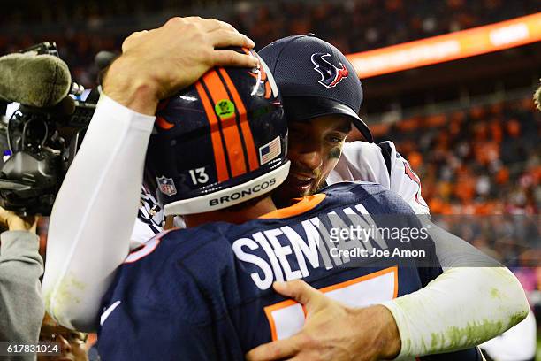 Trevor Siemian of the Denver Broncos hugs Brock Osweiler of the Houston Texans after the fourth quarter of the Broncos' 27-9 win on Monday, October...