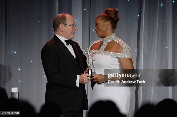 His Serene Highness Prince Albert II of Monaco and Queen Latifah speak onstage during the 2016 Princess Grace Awards Gala with presenting sponsor...
