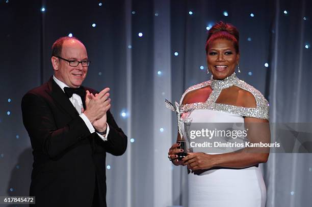 His Serene Highness Prince Albert II of Monaco presents an award to Queen Latifah onstage during the 2016 Princess Grace Awards Gala with presenting...