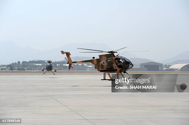 In this photograph taken on September 29 US -made MD-530 Helicopters fly over the air force university in Kabul. Under pressure from the Taliban,...