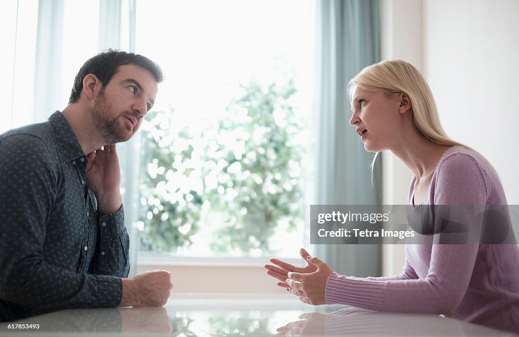Couple sitting at table, talking