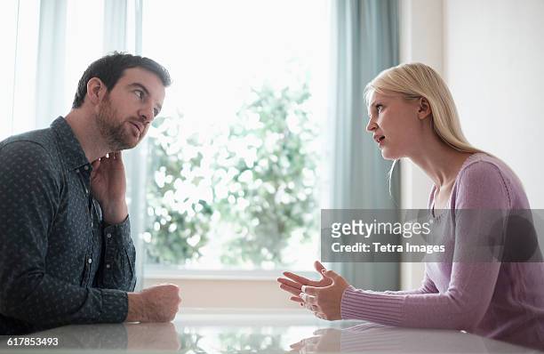 couple sitting at table, talking - dispute stock pictures, royalty-free photos & images