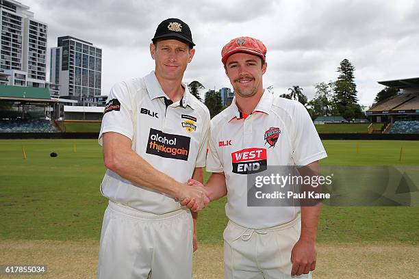 Adam Voges of the Warriors and Travis Head of the Redbacks pose following the coin toss before day one of the Sheffield Shield match between Western...