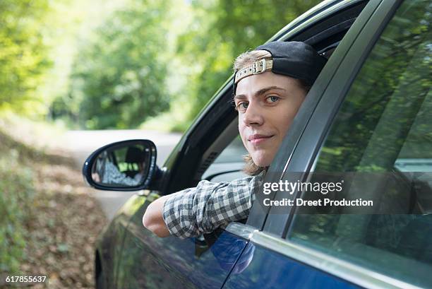 "teenage boy looking out of car window, bavaria, germany" - boy looking over shoulder stock pictures, royalty-free photos & images