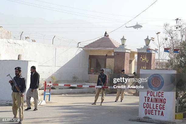 Pakistani security forces stand guard outside the Balochistan Police Training College in Quetta on October 24 after militants attacked the training...