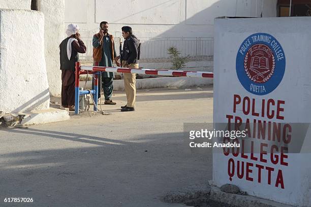 Pakistani security forces stand guard outside the Balochistan Police Training College in Quetta on October 24 after militants attacked the training...