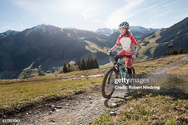 "mountain biker riding on uphill, saalbach-hinterglemm, zell am see, salzburg, austria" - mountain bike girl fotografías e imágenes de stock