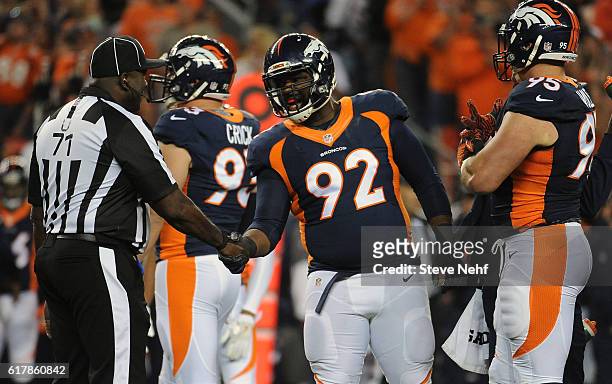 Denver Broncos defensive lineman Sylvester Williams shakes hands with a refereevin the first quarter of the game with the Houston Texans at Sports...