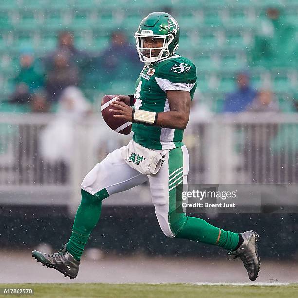 Darian Durant of the Saskatchewan Roughriders scrambles with the ball during the game between the Montreal Alouettes and Saskatchewan Roughriders at...