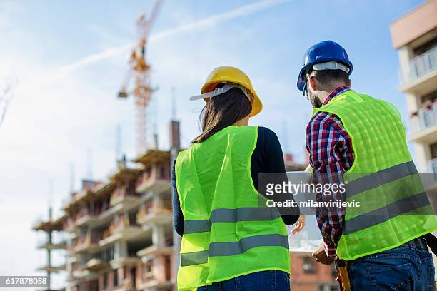 construction worker and his manager checking the progress - control stock pictures, royalty-free photos & images