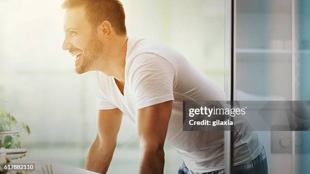 cheerful man in bathroom. - brightly lit bathroom stock pictures, royalty-free photos & images