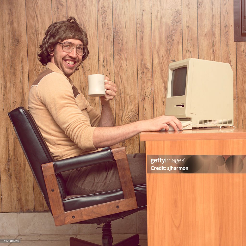 Funny 1980s Computer man at desk with coffee