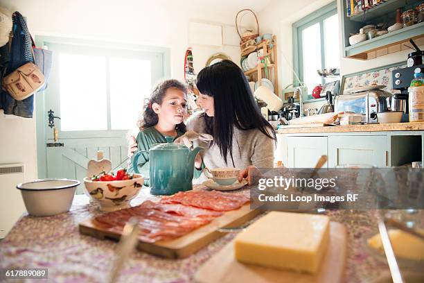 a six year old girl being comforted by her mother at the dinner table - year long stock pictures, royalty-free photos & images
