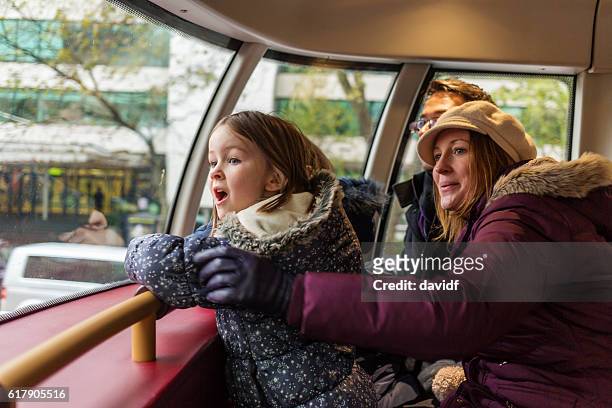 family look in wonder on london bus - london buses stockfoto's en -beelden