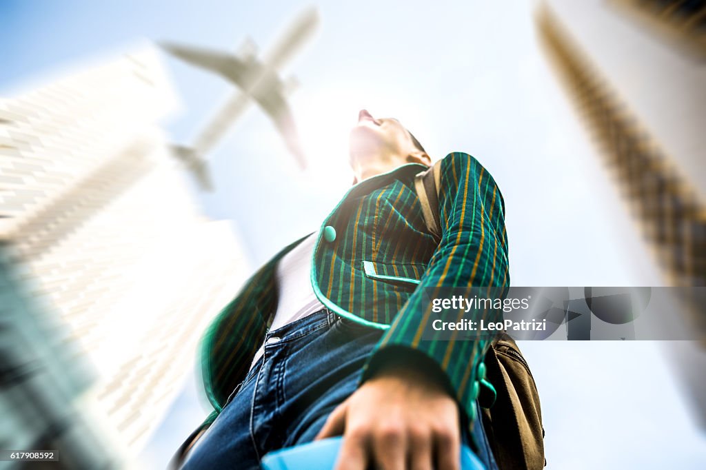 What is your next travel destination? Woman looking a plane