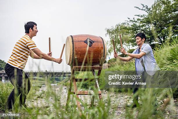 men playing japanese taiko drum outdoors - hitting drum stock pictures, royalty-free photos & images