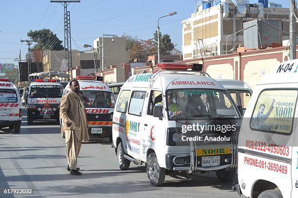 Ambulances are seen in Quetta, Pakistan on October 25 after militants attacked the training college. At least 61 cadets and guards were killed and...