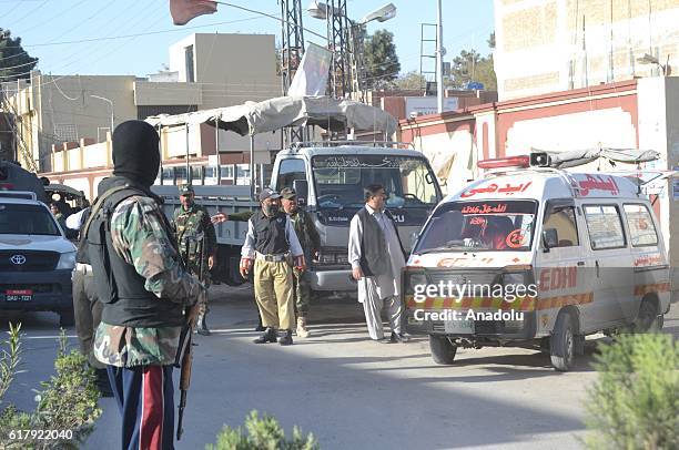 Pakistani security forces stand guard in Quetta, Pakistan on October 25 after militants attacked the training college. At least 61 cadets and guards...