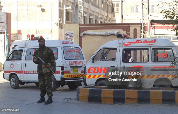 Pakistani security forces member stands guard in Quetta, Pakistan on October 25 after militants attacked the training college. At least 61 cadets and...