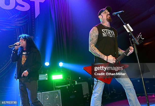 Singer Joey Belladonna of Anthrax joins guitarist John Connolly of Sevendust onstage as they perform the song "Face to Face" during a stop of...