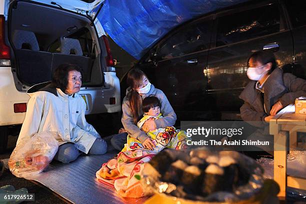 Evacuees spend time outside their cars in fear of aftershocks a day after magnitude 6.6 earthquake hit the area on October 22, 2016 in Kurayoshi,...