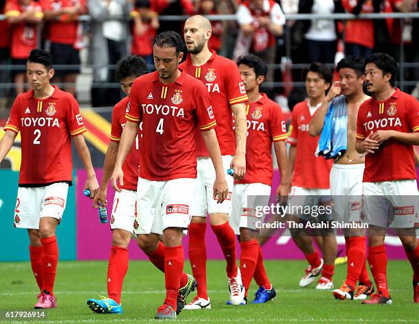 Nagoya Grampus players show their dejection after their 1-1 draw in the J.League match between Nagoya Grampus and Jubilo Iwata at Toyota Stadium on...