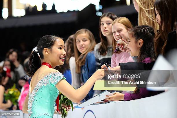 Bronze medalist Mai Mihara of Japan signs autographs for fans after the medal ceremony for the Ladies Singles during day two of the 2016 Progressive...