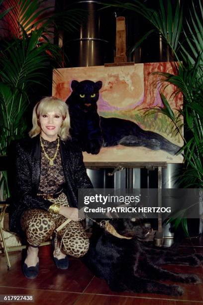 French artist Amanda Lear poses with her black panther during the presentation of her exhibition of paintings at the Grande Arche of la Defense on...