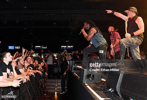 Singer Lajon Witherspoon, guitarist Clint Lowery and bassist Vince Hornsby of Sevendust perform during a stop of the band's Kill the Flaw tour at...
