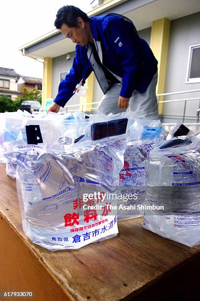 Emergency water bags are distributed a day after magnitude 6.6 earthquake hit the area on October 22, 2016 in Kurayoshi, Tottori, Japan. More than...