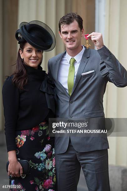 British tennis player Jamie Murray poses with his wife Alejandra Gutierrez at Buckingham Palace in London after he received his Officer of the Order...