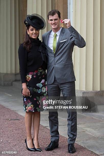 British tennis player Jamie Murray poses with his wife Alejandra Gutierrez at Buckingham Palace in London after he received his Officer of the Order...