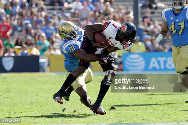 Troy Williams of the Utah Utes gets tackled by Fabian Moreau of the UCLA Bruins during PAC12 college football game at Rose Bowl on October 22, 2016...