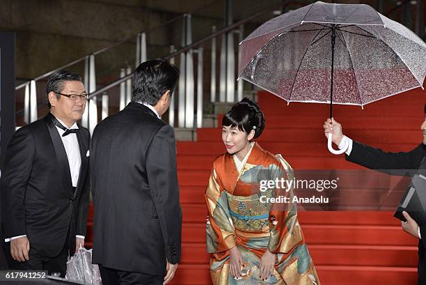 Prime Minister of Japan, Shinzo Abe is welcomed by famous Japanese actress Haru Kuroki as he attends the red carpet of the Opening Ceremony of the...