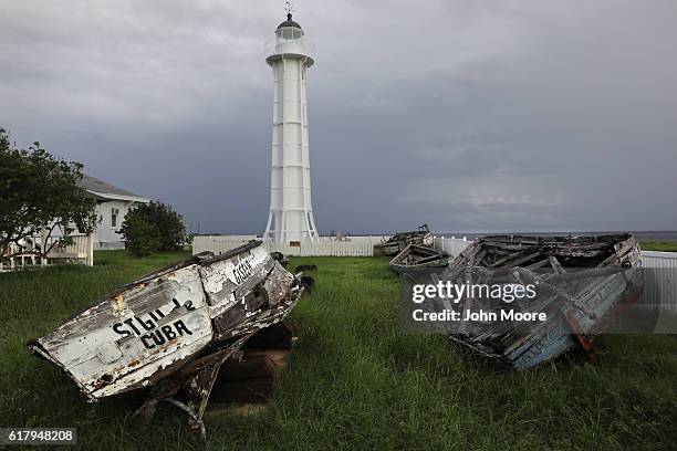 Lighthouse stands on the shoreline near wrecks of Haitian boats near the U.S. Prison known as "Gitmo" on October 21, 2016 at the U.S. Naval Station...